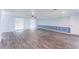 Spacious living room with wood-look floors, decorative wall trim, and abundant natural light at 8705 Village Mill Row, Hudson, FL 34667