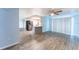 Open-concept living room and kitchen with tile floors, modern appliances, and lots of natural light from sliding glass doors at 8705 Village Mill Row, Hudson, FL 34667