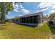Lovely screened-in porch extends the living space outdoors, perfect for relaxing and entertaining at 8705 Village Mill Row, Hudson, FL 34667