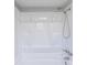 White shower with built in shelving, updated shower head, and a window for natural light at 8705 Village Mill Row, Hudson, FL 34667