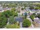 This aerial view shows a charming neighborhood with mature trees and well-maintained homes at 9040 Mark Twain Ln, Port Richey, FL 34668