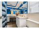 Bathroom with blue accent walls, large mirror, and ample counter space at 9040 Mark Twain Ln, Port Richey, FL 34668