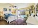 Bright bedroom features a white bed frame, pool view, and nautical decor at 9040 Mark Twain Ln, Port Richey, FL 34668