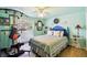 Cozy bedroom featuring a ceiling fan, work out equipment, and a queen-sized bed at 9040 Mark Twain Ln, Port Richey, FL 34668