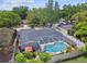The aerial view shows a private screened-in pool and fenced backyard, great for entertaining at 9040 Mark Twain Ln, Port Richey, FL 34668