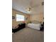 Cozy bedroom featuring carpet, a ceiling fan, and comfortable sleeping arrangements that create a serene retreat at 9350 Barrington Ln, Port Richey, FL 34668