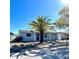 This single-story home features a palm tree in the front yard, attached garage, and a well-maintained lawn and inviting entrance at 9350 Barrington Ln, Port Richey, FL 34668
