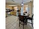 This kitchen showcases stainless steel appliances and a cozy dining area, perfect for Gathering meals and entertaining guests at 9350 Barrington Ln, Port Richey, FL 34668