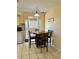 This kitchen offers a cozy dining area, tile floors, and functionality for enjoying quick meals or entertaining at 9350 Barrington Ln, Port Richey, FL 34668