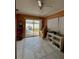 Living room with white tile floors and sliding glass doors leading to backyard and patio area at 9350 Barrington Ln, Port Richey, FL 34668