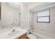 Bright bathroom with tub-shower combo, white tile, and large mirror above the vanity at 1005 Indigo Run Ct, Spring Hill, FL 34609