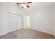 Spacious bedroom features a ceiling fan and large closet for ample storage space at 1005 Indigo Run Ct, Spring Hill, FL 34609
