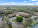 Expansive community center with a large pool, surrounded by lush greenery and a circular driveway for easy access at 1005 Indigo Run Ct, Spring Hill, FL 34609