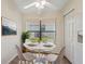 Bright dining area features a white table and seating for four, with natural light at 1005 Indigo Run Ct, Spring Hill, FL 34609