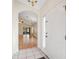 Entryway with tile flooring and a view into the bright living room with wood floors and a chandelier at 1005 Indigo Run Ct, Spring Hill, FL 34609