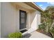 Close up of a front door and sidelight with manicured landscaping near the walkway at 1005 Indigo Run Ct, Spring Hill, FL 34609