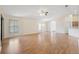 Open-concept living room featuring wood flooring, large windows, and access to adjacent rooms at 1005 Indigo Run Ct, Spring Hill, FL 34609