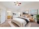 This main bedroom has a ceiling fan, with an ensuite bath, and a walk-in closet at 1005 Indigo Run Ct, Spring Hill, FL 34609