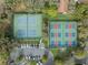Aerial view of the community's well-maintained tennis and pickleball courts with convenient parking at 1005 Indigo Run Ct, Spring Hill, FL 34609