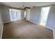 Spacious bedroom featuring neutral paint, carpet flooring and a ceiling fan at 10921 Stamford Dr, Port Richey, FL 34668
