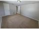 Bedroom featuring neutral paint, carpet flooring and access to additional rooms at 10921 Stamford Dr, Port Richey, FL 34668