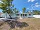 Charming single-story home featuring a well-maintained yard and a brick and siding facade at 10921 Stamford Dr, Port Richey, FL 34668
