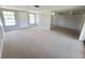 Expansive living area featuring carpet flooring, neutral walls and ample natural light at 10921 Stamford Dr, Port Richey, FL 34668