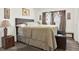 Cozy bedroom featuring wood floors, neutral paint and a large bed with side tables at 11256 Holbrook St, Spring Hill, FL 34609