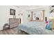Comfortable bedroom with wood-look flooring, large window, and a view to the outside at 11256 Holbrook St, Spring Hill, FL 34609