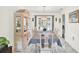 Bright dining space features a large table, modern chandelier, and a view of the pool through a window at 11256 Holbrook St, Spring Hill, FL 34609