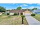 Charming single-story home with an attached garage and manicured front yard at 11256 Holbrook St, Spring Hill, FL 34609