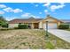 Charming home with a manicured lawn, attached garage, and tasteful landscaping on a sunny day at 11256 Holbrook St, Spring Hill, FL 34609