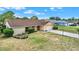 Single-story home features a well-manicured lawn and attached two car garage on a sunny day at 11256 Holbrook St, Spring Hill, FL 34609