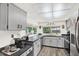 Well-lit kitchen featuring updated appliances, neutral cabinets, and a large window at 11256 Holbrook St, Spring Hill, FL 34609