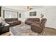 Spacious living room features wood floors, neutral paint and comfortable leather seating at 11256 Holbrook St, Spring Hill, FL 34609