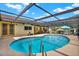 Sparkling in-ground pool surrounded by a screened enclosure and patio, perfect for outdoor entertaining at 11256 Holbrook St, Spring Hill, FL 34609
