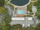 Bird's-eye view of the community pool, clubhouse, shuffleboard courts, and ample parking at 11310 Carriage Hill Dr # 4, Port Richey, FL 34668