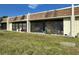A lawn and screened in patio offers relaxing outdoor space, with chairs and small decorations at 11310 Carriage Hill Dr # 4, Port Richey, FL 34668