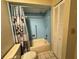 Clean bathroom featuring blue tile shower, neutral fixtures, and standard closet at 11310 Carriage Hill Dr # 4, Port Richey, FL 34668