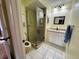 Well-lit bathroom featuring a walk-in shower and updated vanity at 11310 Carriage Hill Dr # 4, Port Richey, FL 34668