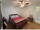 Comfortable bedroom features a ceiling fan, closet, and soft natural light at 11310 Carriage Hill Dr # 4, Port Richey, FL 34668