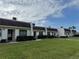 Exterior showcasing multiple unit facades with well-maintained lawns at 11310 Carriage Hill Dr # 4, Port Richey, FL 34668