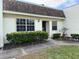 Charming front exterior with manicured landscaping and visible unit number at 11310 Carriage Hill Dr # 4, Port Richey, FL 34668