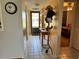 Hallway with tiled floor and a view into bedroom and out the front door at 11310 Carriage Hill Dr # 4, Port Richey, FL 34668