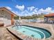 Inviting community hot tub near the pool, with chairs for relaxing and enjoying the surroundings at 11310 Carriage Hill Dr # 4, Port Richey, FL 34668