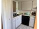 The kitchen features updated white cabinets, black appliances, and lots of storage space at 11310 Carriage Hill Dr # 4, Port Richey, FL 34668