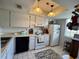 Bright kitchen with white appliances, cabinetry, tiled floor, and recessed lights at 11310 Carriage Hill Dr # 4, Port Richey, FL 34668