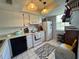 Bright kitchen with a white refrigerator, stove, dishwasher and tile flooring at 11310 Carriage Hill Dr # 4, Port Richey, FL 34668