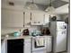 A kitchen with white cabinets and appliances, including a dishwasher and stove at 11310 Carriage Hill Dr # 4, Port Richey, FL 34668