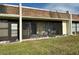 A screened patio with outdoor furniture and decorations overlooks a grassy area and flower bed at 11310 Carriage Hill Dr # 4, Port Richey, FL 34668